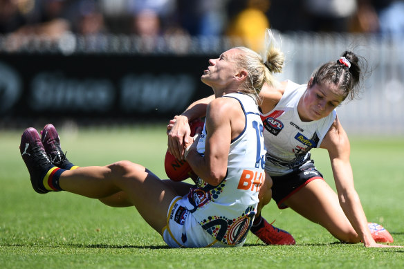 Jumper clash: Adelaide and St Kilda were both wearing predominantly white strips on Sunday.