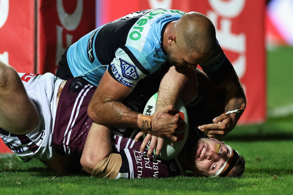 Will Kennedy tries valiantly to stop Lachlan Croker scoring for the Sea Eagles.