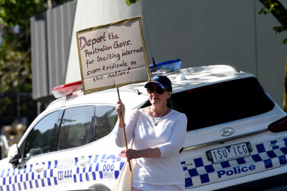 A protester holds a sign outside Rod Laver Arena on Monday afternoon.
