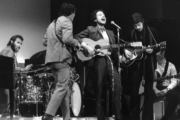 Bob Dylan (centre) performing with Robertson and The Band at Carnegie Hall in 1968.