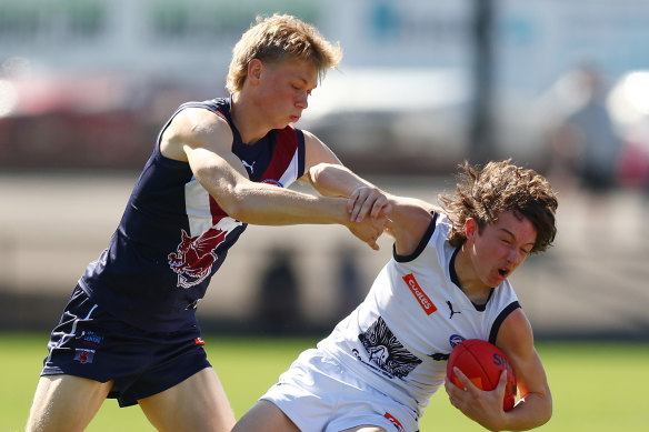 River Stevens (right) of Geelong Falcons is trackled during a Coates League preliminary final last year.
