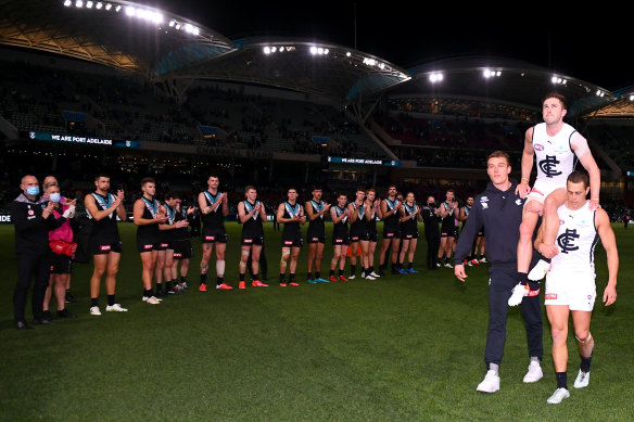 Marc Murphy is chaired off the ground by Patrick Cripps and Ed Curnow.
