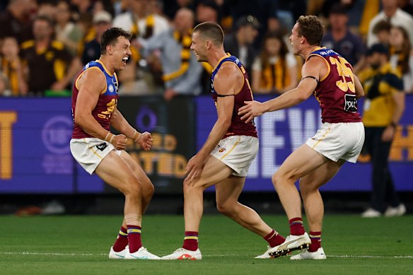 Brisbane Lions trio Hugh McCluggage, Josh Dunkley and Ryan Lester celebrate their last-gasp victory.