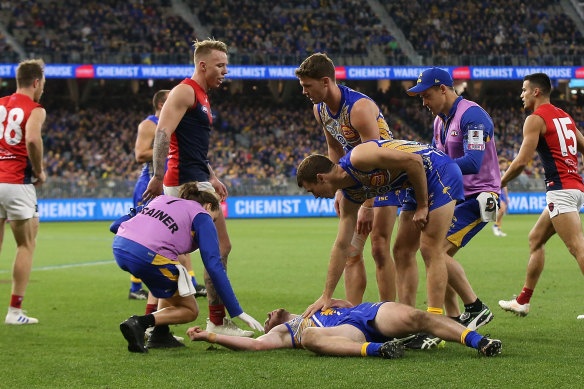 Daniel Venables being assessed after colliding with another player during a match in 2019.