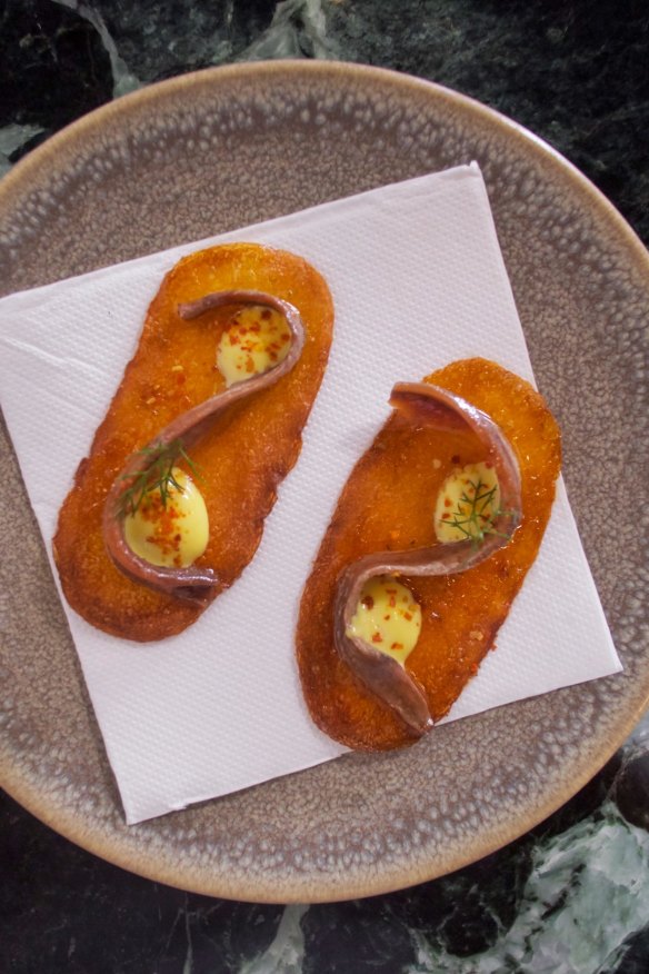 Anchovy on crisp potato.