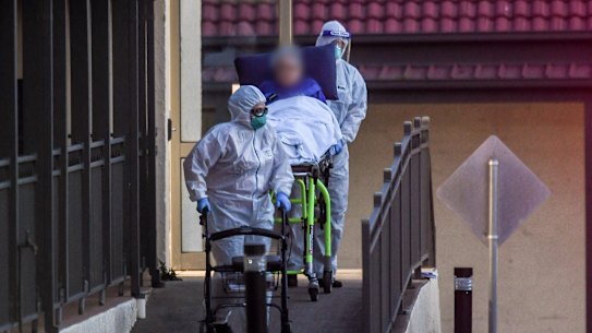 A resident is evacuated from St Basil’s aged care home in July last year.