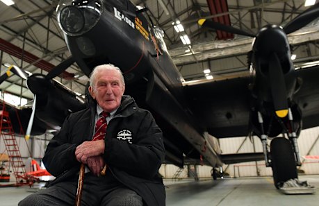 Johnny Johnson, the last survivor of the original Dambusters of 617 Squadron, sits beneath an Avro Lancaster bomber at RAF Coningsby, Lincolnshire.