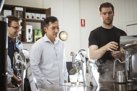 Head barista Matt Coulson talks customers Helen, Chris and Tin through making their own coffee.