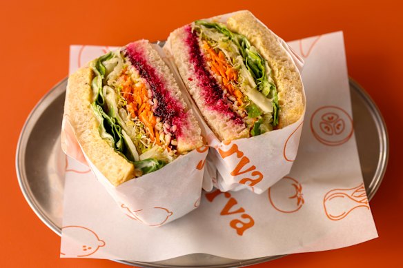 Salad sandwich with beetroot relish, carrots, cheddar, lime pickle aioli, sauerkraut and pickled fennel. 