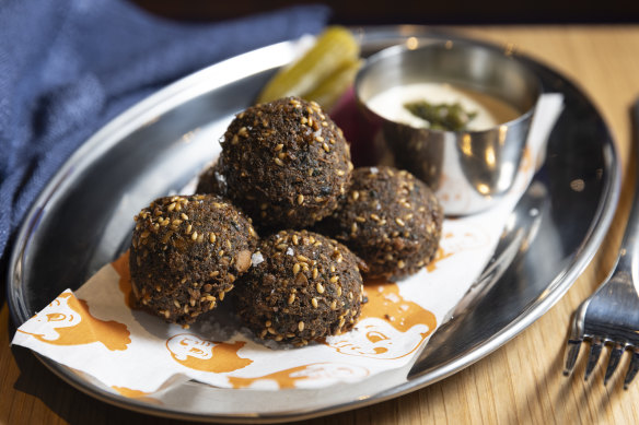 Falafels, crisp outside and fluffy within, are served with runny tahini.