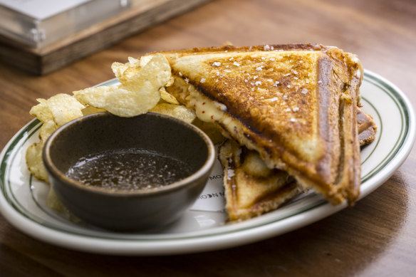 The jaffle is served with potato chips and fermented honey.