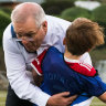 Prime Minister Scott Morrison tackles Luca to the ground in a trial game of soccer in Tasmania. 