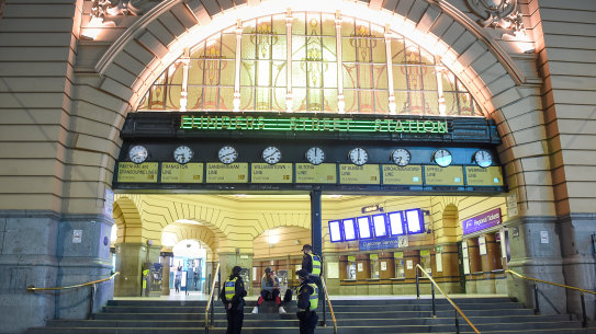 Flinders Street Station clocks just after 8pm on Sunday as Melbourne's curfew came into effect.