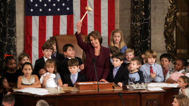 Nancy Pelosi opens the 110th United States Congress in 2007, surrounded by politicians' children and grandchildren, during her first stint as House speaker.