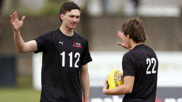Josh Gibcus high-fives Judson Clarke at the AFL Draft Victoria training day at Trevor Barker Oval recently.