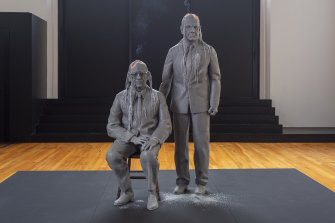 The lifelike wax figures of the two men slowly melting.