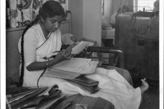 Lata Mangeshkar reading a fan letter in 1964.
