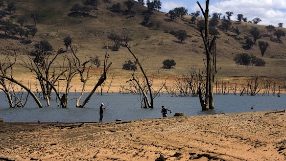 A couple of fishermen on the enlarging banks of Lake Hume, near Albury, where water levels are low due to drought.  
