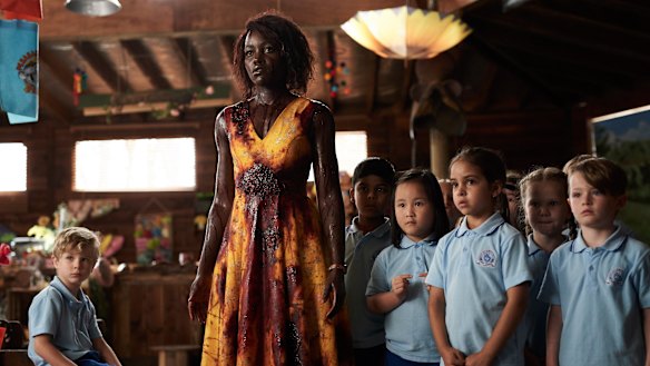 Lupita Nyong'o as Miss Caroline with her kindergarten class in Little Monsters.