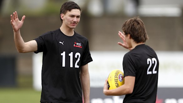Josh Gibcus high-fives Judson Clarke at the AFL Draft Victoria training day at Trevor Barker Oval recently.