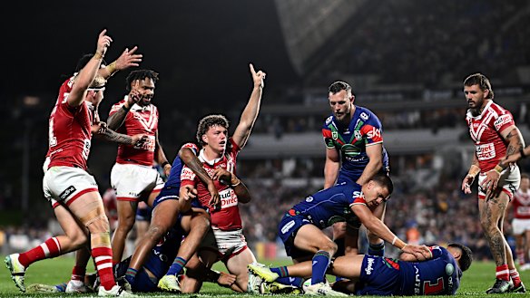 Dolphins players celebrate Jack Bostock’s late try in their upset win over the Warriors.
