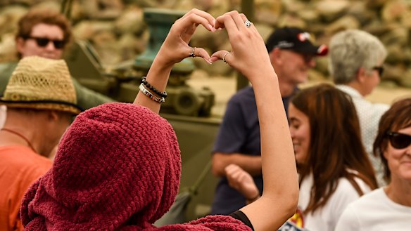 People left behind in Mallacoota farewell their loved ones aboard HMAS Choules on Friday.