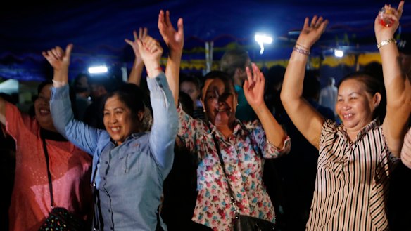 Thais celebrate after the final evacuation from Tham Luang is announced. 