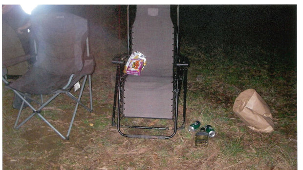 The couple's abandoned camp chairs, beer cans and Pizza Shapes.