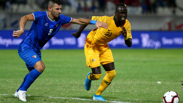 Awer Mabil of Australia and Fahad Alhajeri of Kuwait in action.
