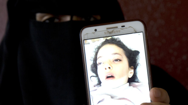 Aisha's mum Muna Awad shows a photo of her sent to her parents while she was in a Jerusalem hospital.
