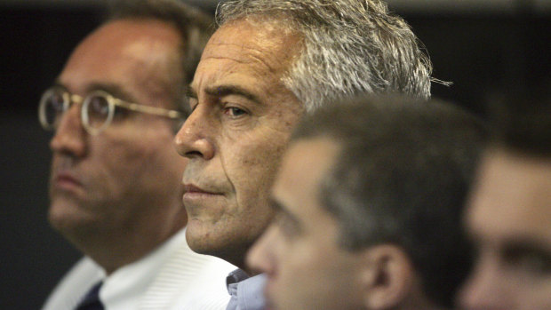 Jeffrey Epstein, centre, left behind an estate worth more than $US600 million following his death.