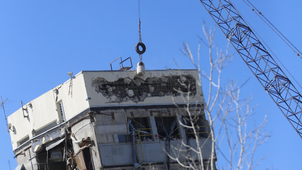 A wrecking ball smashes the "Leaning Tower of Dallas."