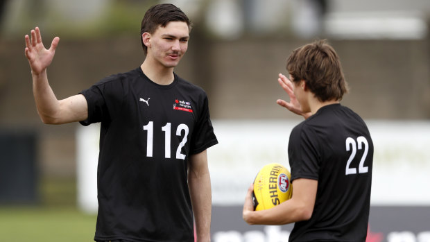 Josh Gibcus high-fives Judson Clarke at the AFL Draft Victoria training day at Trevor Barker Oval recently.