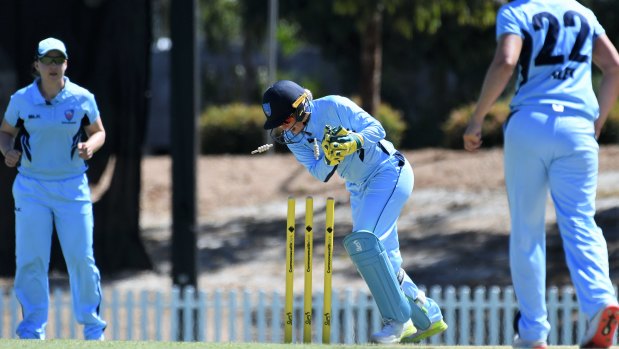 Star in front of and behind the stumps: Alyssa Healy completes a run-out during the NSW Breakers' victory over South Australia in Adelaide.