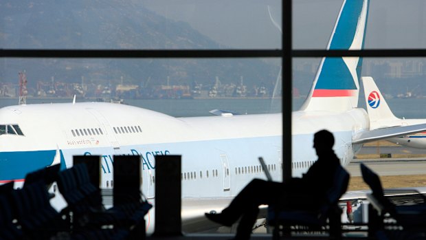 A traveller works at a boarding gate at Hong Kong International Airport.