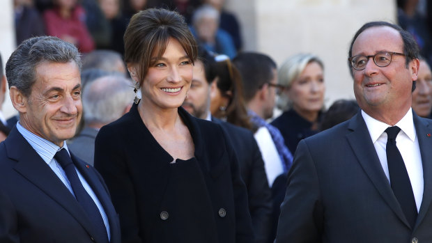 Former French presidents Nicolas Sarkozy, left, and Francois Hollande, with Sarkozy's wife Carla Bruni last year.
