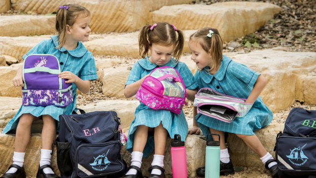 Identical triplets, from left to right, Chloe, Eliza and Bronte. They are are among a record cohort of children beginning kindergarten at a NSW public school this term.