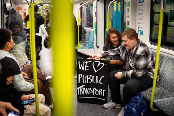 Melburnian Ash Williamson (left) and friend Steven McPhearson on the first southbound train after earlier catching the inaugural service from Bankstown.