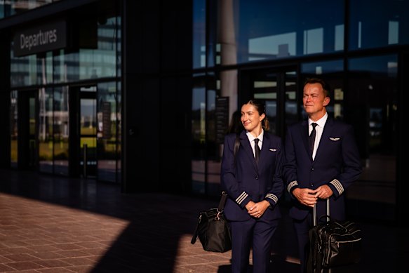 Jetstar first officer Aglaya Papadokokolakis, 25, from Blacktown, and captain Guy Proctor, 51, from the Gold Coast outside the terminal.
