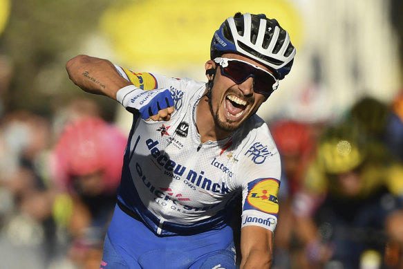 Julian Alaphilippe crosses to win stage 2 – and take the yellow jersey – on Sunday.