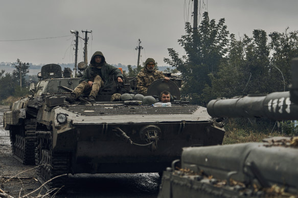 Ukrainian military vehicles move into freed territory in the Kharkiv region.