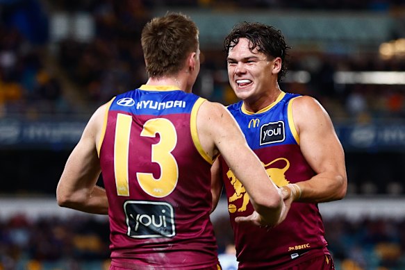 Logan Morris and Cam Rayner of the Lions celebrate a goal.