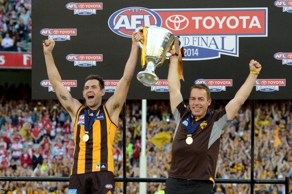 Enjoying the moment: Luke Hodge and Alastair Clarkson after the 2014 grand final.
