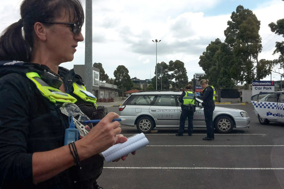 Police issue fines to people at a protest in support of refugees at the Mantra hotel in Preston.