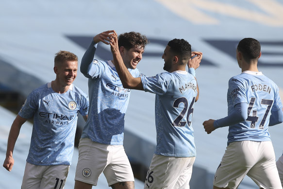 John Stones (second from left) celebrates after scoring for City.