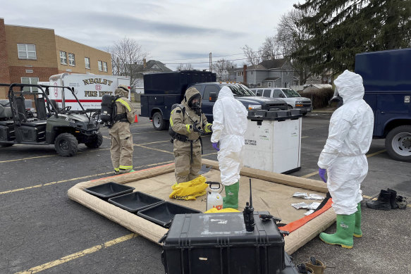 Ohio National Guard Civil Support Team members prepare to enter an incident area in East Palestine, Ohio, to assess remaining hazards with a lightweight inflatable decontamination system.