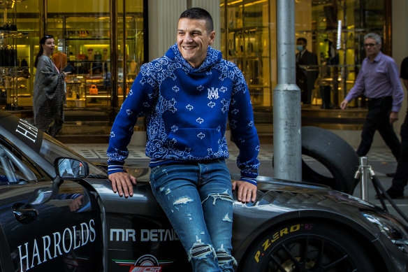Ross Poulakis with a luxury car in 2022.