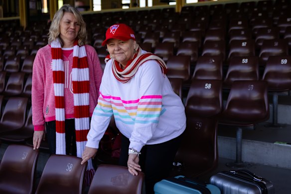 Sally Edmiston (left) and her sister, Amanda, attend an open practice for the Sydney Swans at the SCG on Thursday.