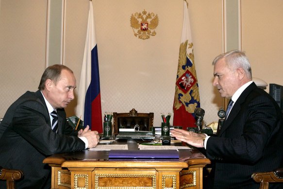 Victor Rashnikov (right) with Vladimir Putin, last month transferred a $US4 billion stake in one of Russia’s biggest steelmakers from a shell company in Cyprus back to his home country, two weeks before he was sanctioned by the EU.