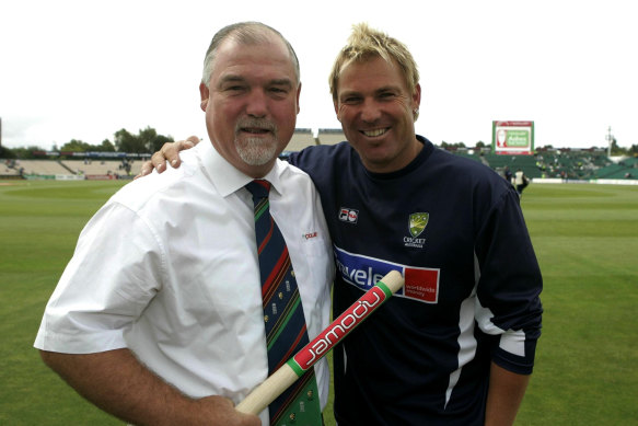 Mike Gatting congratulates Shane Warne for passing 600 Test wickets in 2005.